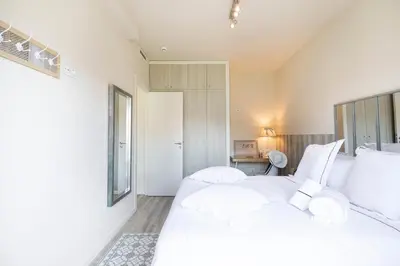 a bedroom with a large white bed with white pillows at Chic Gran Via Apartment in Barcelona