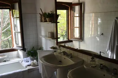 a bathroom with a sink and a mirror and a tub at Mas Peirot Sitges in Cunit