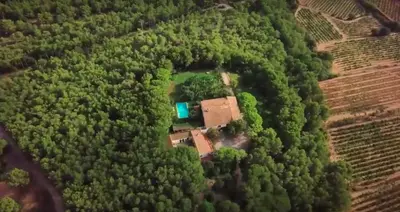 an aerial view of a house in the middle of a forest at Mas Peirot Sitges in Cunit
