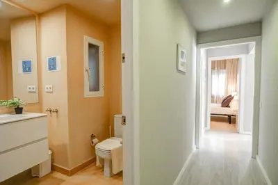 a bathroom with a sink and a toilet in a room at La Gioia 1 by Hello Homes Sitges in Sitges