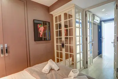 a bedroom with a bed and a glass door at La Gioia 2 by Hello Homes Sitges in Sitges
