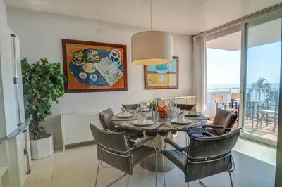 a dining room with a table and chairs at La Gioia 2 by Hello Homes Sitges in Sitges