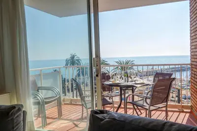 a balcony with a table and chairs and the ocean at La Gioia 2 by Hello Homes Sitges in Sitges