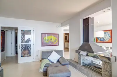 a living room with a fireplace and a couch at La Gioia 2 by Hello Homes Sitges in Sitges