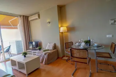 a living room with a table and a couch at La Gioia 3 by Hello Homes Sitges in Sitges