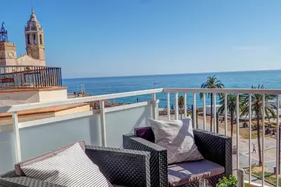 a balcony with chairs and a view of the ocean at La Gioia 3 by Hello Homes Sitges in Sitges