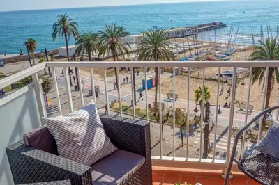 a balcony with a view of a beach and the ocean at La Gioia 3 by Hello Homes Sitges in Sitges