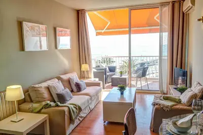 a living room with a couch and a table at La Gioia 3 by Hello Homes Sitges in Sitges