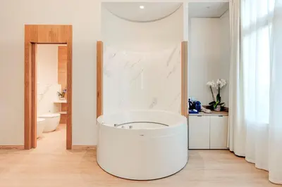 a bathroom with a large white tub in a room at Hotel Boutique Mirlo Barcelona in Barcelona