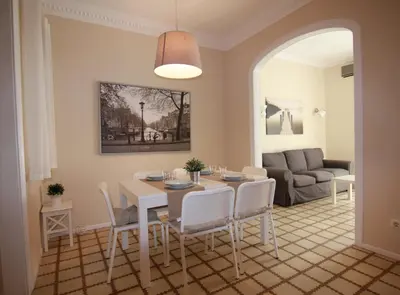 a living room with a table and chairs and a couch at CORSEGA - Apartment in the center of Barcelona in Barcelona