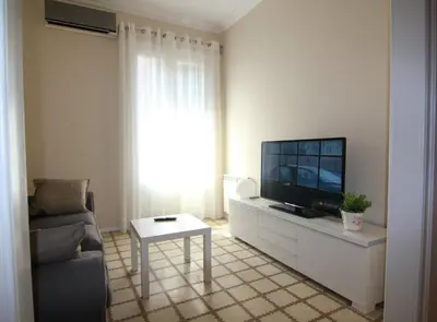 a living room with a tv and a couch and a table at CORSEGA - Apartment in the center of Barcelona in Barcelona