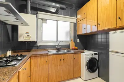 a kitchen with a sink and a washing machine at Rafael Apartment by Olala Homes in Hospitalet de Llobregat