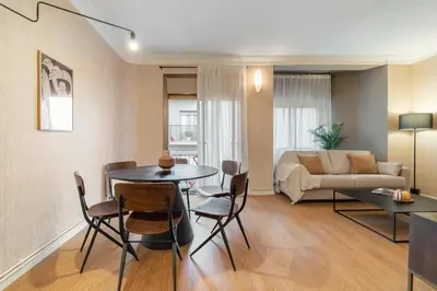 a living room with a table and chairs and a couch at Rafael Apartment by Olala Homes in Hospitalet de Llobregat