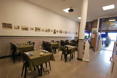 a dining room with tables and chairs in a restaurant at Hotel Tres Leones in Vilassar de Mar