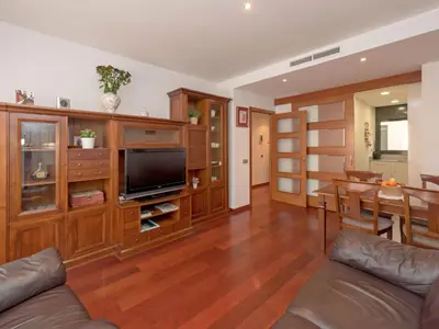 a living room with a television and a dining room at Apartment Poblenou by Interhome in Barcelona