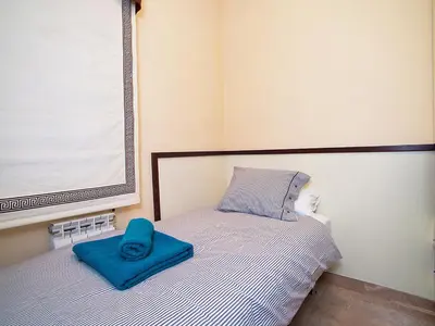 a bedroom with a bed with a blue pillow on it at Apartment Pg Gracia - Valencia by Interhome in Barcelona