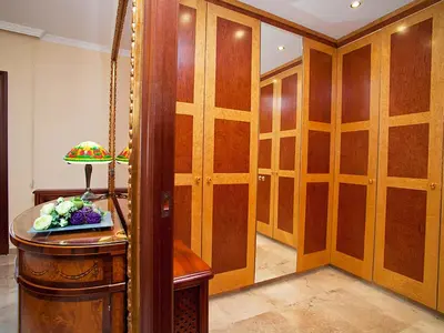 a dressing room with wooden cabinets and a table at Apartment Pg Gracia - Valencia by Interhome in Barcelona
