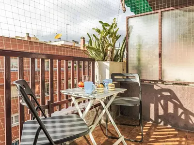 a table and two chairs on a balcony at Apartment Sants-Les Corts Galileu by Interhome in Barcelona
