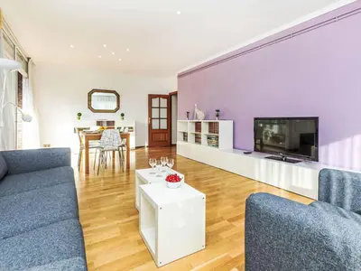 a living room with a purple wall at Apartment Sants-Les Corts Galileu by Interhome in Barcelona
