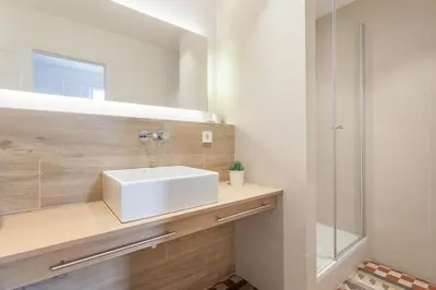 a bathroom with a white sink and a shower at Flateli Pelayo H5 in Barcelona