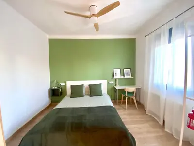 a bedroom with a bed and a ceiling fan at Sunny Apt Barcelona 22 in Barcelona