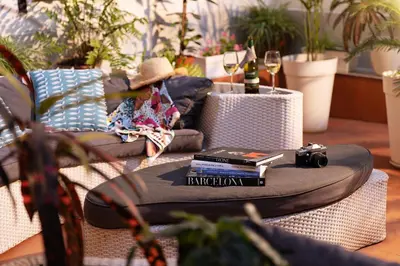 a table with a camera and books on it at Amra Barcelona Caspe in Barcelona
