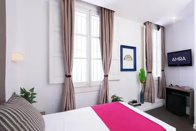 a bedroom with a large bed and a window at Amra Barcelona Caspe in Barcelona