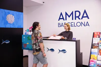 a man and a woman standing at a counter at Amra Barcelona Caspe in Barcelona