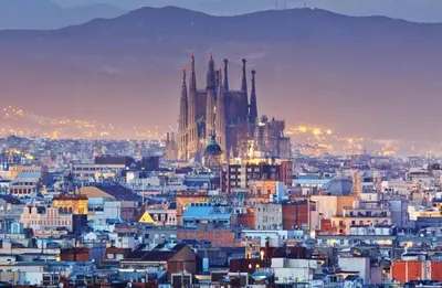 a view of a city at night with a cathedral at Romantic In Trendy Gracia in Barcelona