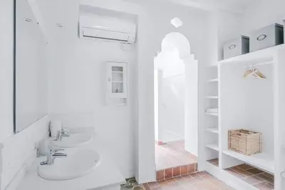 a white bathroom with a sink and a toilet at Exquisite&historic Flat With Rooftop in Barcelona