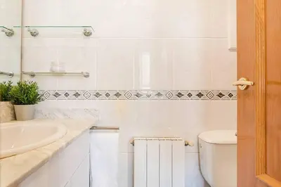 a white bathroom with a sink and a toilet at Vive Como Un Barcelons in Barcelona