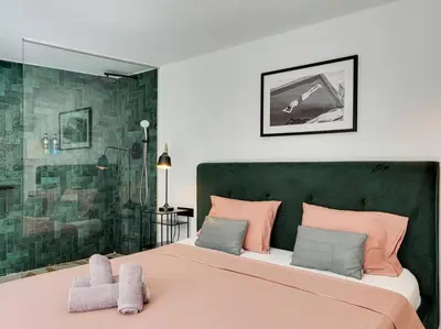 a bedroom with a large bed and a shower at Casa Maria Townhouse- terrace-4 bedrooms in Hospitalet de Llobregat