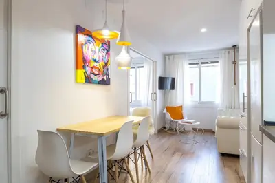 a kitchen and dining room with a table and chairs at Besos Beach Gem 1 By MyRentalHost in Sant Adria de Besos