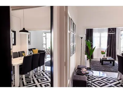 a living room with a table and a dining room at CENTRAL STYLISH EIXAMPLE - Casa Antonio By MyRentalHost in Barcelona