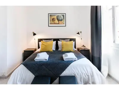 a bedroom with a bed with two towels on it at CENTRAL STYLISH EIXAMPLE - Casa Antonio By MyRentalHost in Barcelona