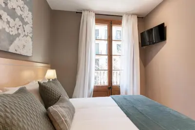 a bedroom with a bed and a window at Casa PILAR Central By MyRentalHost in Barcelona