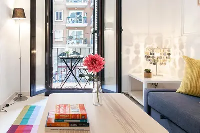 a living room with a vase with a flower on a coffee table at Sagrada Familia ART Apt By MyRentalHost in Barcelona