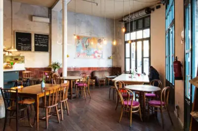 a dining room with tables and chairs in a restaurant at Sagrada Familia ART Apt By MyRentalHost in Barcelona