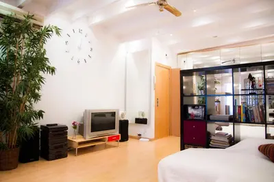 a bedroom with a bed and a tv in a room at Studio Gracia By MyRentalHost in Barcelona