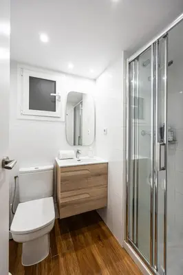 a bathroom with a toilet and a sink and a shower at Live Like A Local In Bcn in Barcelona