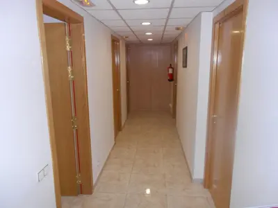 a hallway with two doors and a tile floor at Hostal Ca La Irene in San Vicente de Castellet