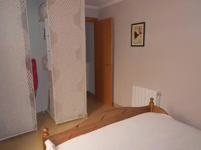 a bedroom with a bed and a door to a closet at Cozy Apartment Near The Beach in Barcelona
