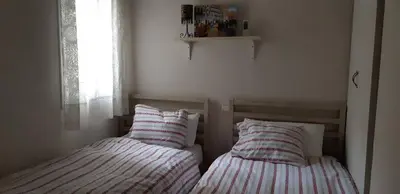 two beds sitting next to each other in a bedroom at Cozy Apartment Near The Beach in Barcelona