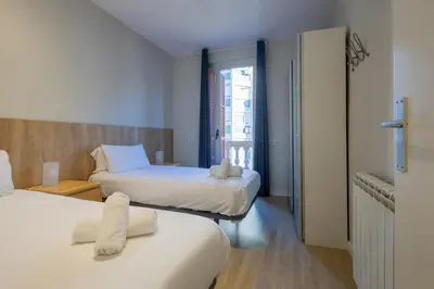 a hotel room with two beds and a window at Housalia Sagrada Familia Views in Barcelona