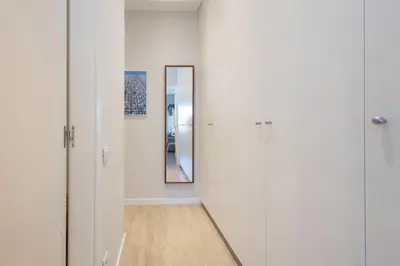 a hallway with a mirror and white walls at Housalia Sagrada Familia Views in Barcelona