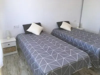 two beds sitting next to each other in a room at CASA DEL BOSQUE CON PISCINA EN SITGES in Sant Pere de Ribes