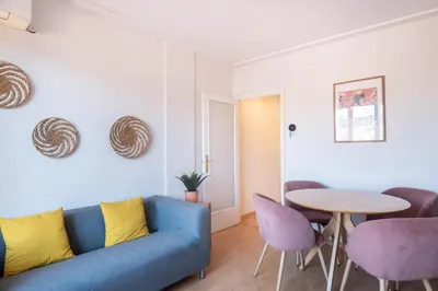 a living room with a blue couch and a table at Penthouse Apartment with Terrace in Barcelona City Center in Barcelona