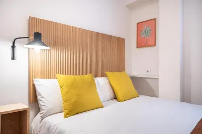 a bedroom with a bed with yellow pillows at Penthouse Apartment with Terrace in Barcelona City Center in Barcelona
