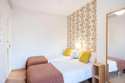 a bedroom with two beds and a mirror at Penthouse Apartment with Terrace in Barcelona City Center in Barcelona
