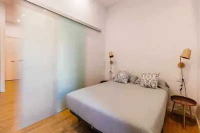 a bedroom with a bed with two pillows on it at Cozy & Central Apartment in Barcelona